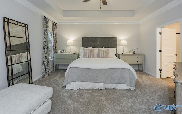 bedroom featuring light carpet, ceiling fan, and a tray ceiling