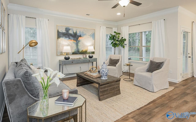 sitting room featuring crown molding, wood-type flooring, and ceiling fan