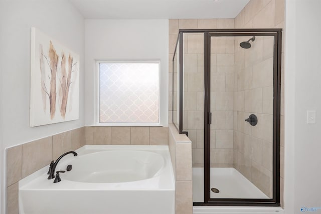 bathroom featuring separate shower and tub