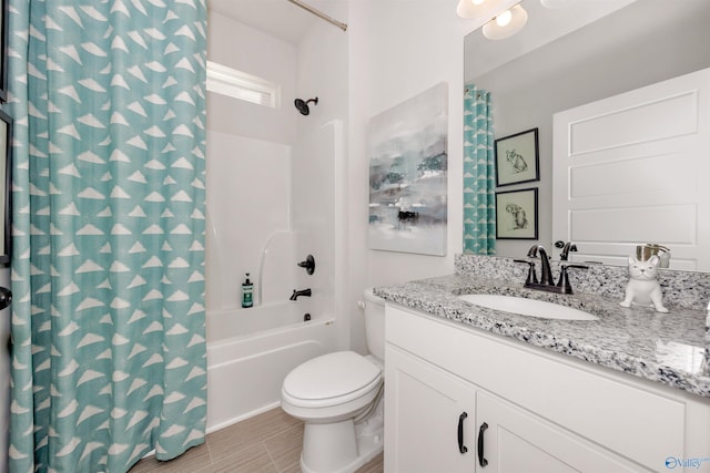 full bathroom with vanity, shower / tub combo with curtain, and toilet