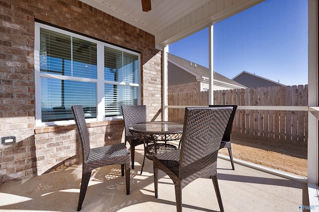 sunroom / solarium featuring ceiling fan