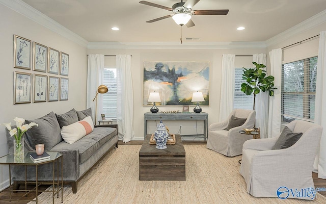 living area featuring ceiling fan, crown molding, and light hardwood / wood-style floors