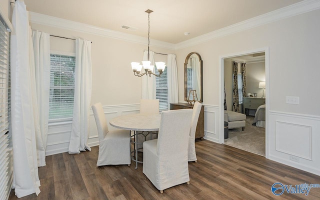 dining room with crown molding, dark wood-type flooring, and an inviting chandelier