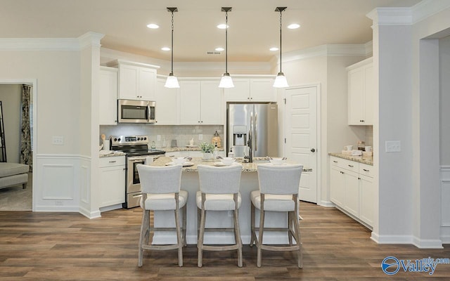 kitchen with light stone counters, white cabinets, and stainless steel appliances