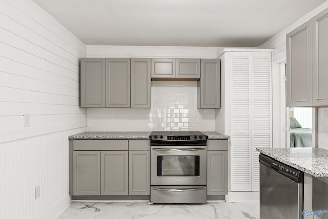 412 Oshaughnessy Ave NE, Huntsville, AL 35801 - kitchen with gray cabinetry, stainless steel appliances, light marble finish floors, light stone counters, and decorative backsplash