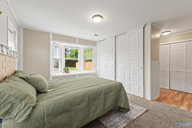 412 Oshaughnessy Ave NE, Huntsville, AL 35801 - carpeted bedroom featuring crown molding and two closets
