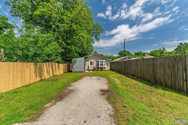 412 Oshaughnessy Ave NE, Huntsville, AL 35801 - view of yard featuring driveway and an outbuilding