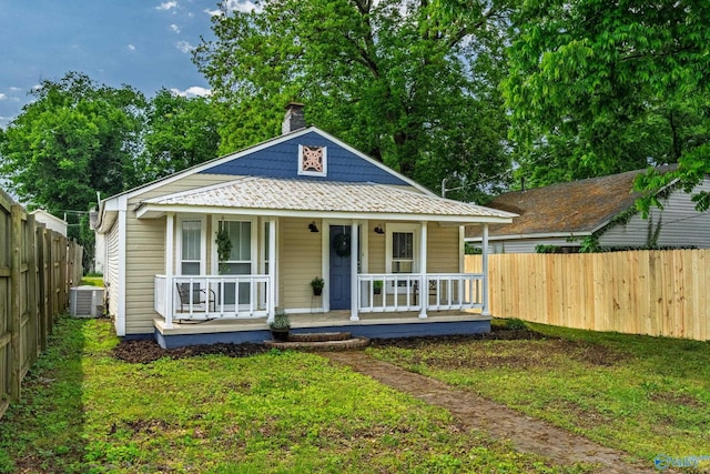 412 Oshaughnessy Ave NE, Huntsville, AL 35801 - view of front of home featuring covered porch, central AC, a fenced backyard, and a chimney