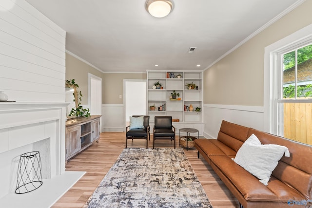 412 Oshaughnessy Ave NE, Huntsville, AL 35801 - living area with ornamental molding, light wood-type flooring, and a wainscoted wall