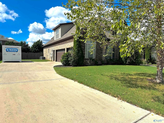 view of front of property with a garage and a front lawn