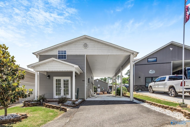 view of front of home with french doors and a carport