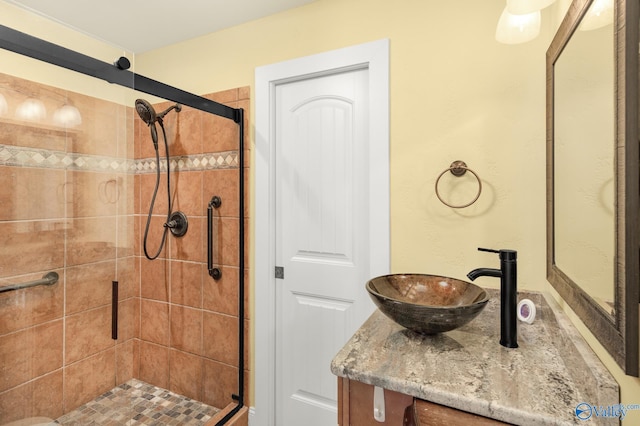 bathroom with vanity and a shower with shower door