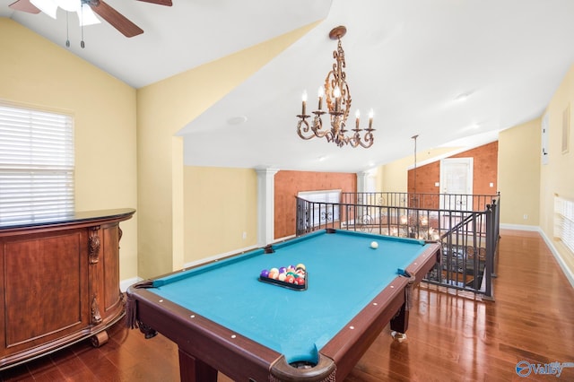 playroom featuring ornate columns, vaulted ceiling, dark hardwood / wood-style floors, and ceiling fan with notable chandelier