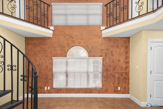 staircase featuring a towering ceiling