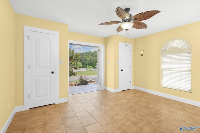 foyer entrance with plenty of natural light, light tile patterned floors, and ceiling fan