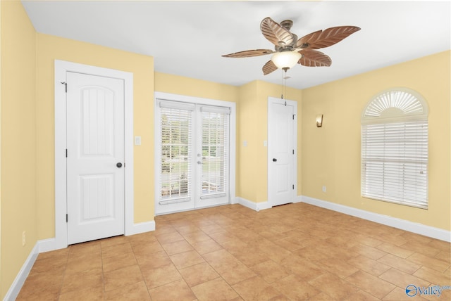 tiled spare room with french doors and ceiling fan