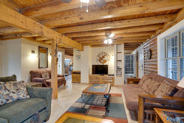 living room with beamed ceiling, ceiling fan, and log walls