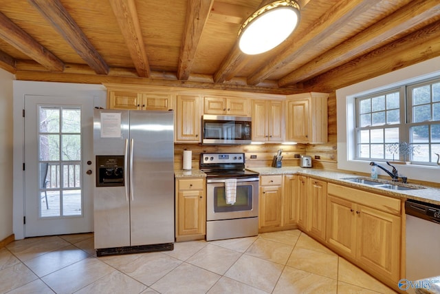 kitchen featuring sink, stainless steel appliances, beamed ceiling, and light brown cabinets