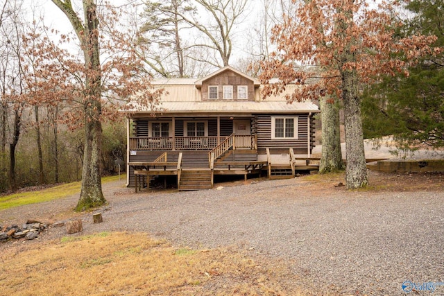 log cabin featuring covered porch