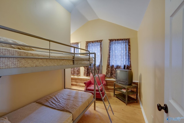 bedroom featuring lofted ceiling and wood-type flooring