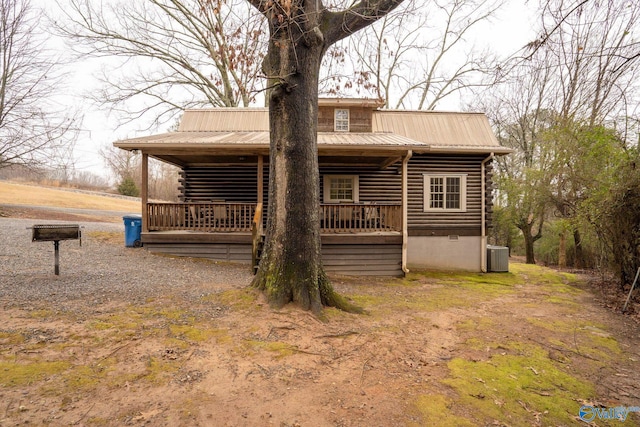 back of house with central AC unit and covered porch