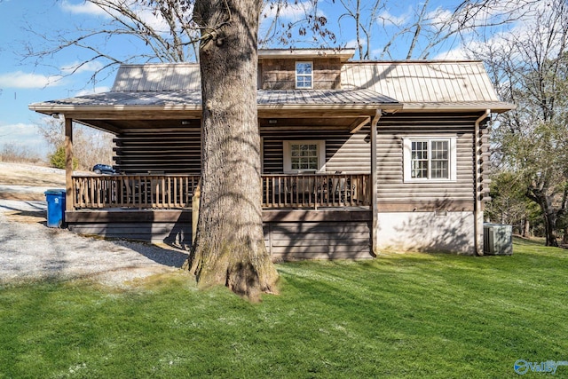 back of property with a wooden deck, a yard, and central AC