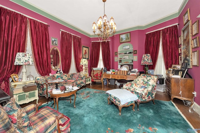 living area with wood-type flooring, ornamental molding, and an inviting chandelier