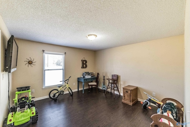 miscellaneous room featuring a textured ceiling and dark wood-type flooring