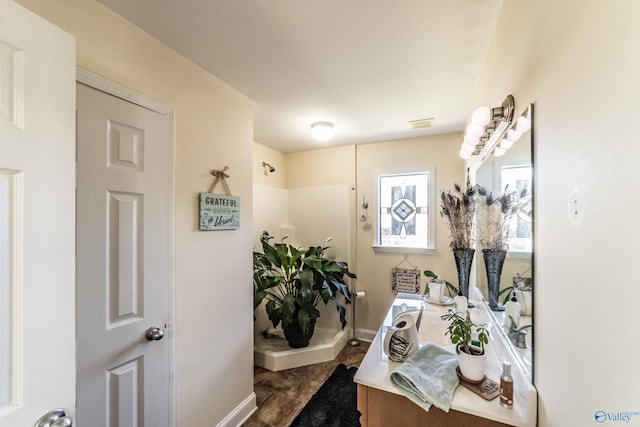 bathroom featuring vanity and walk in shower