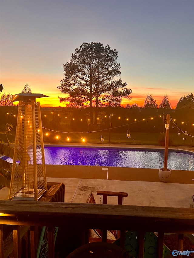 pool at dusk with a water view