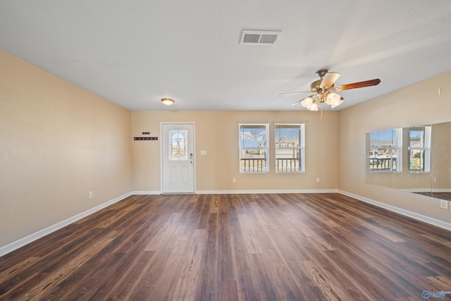 interior space with ceiling fan and dark hardwood / wood-style floors