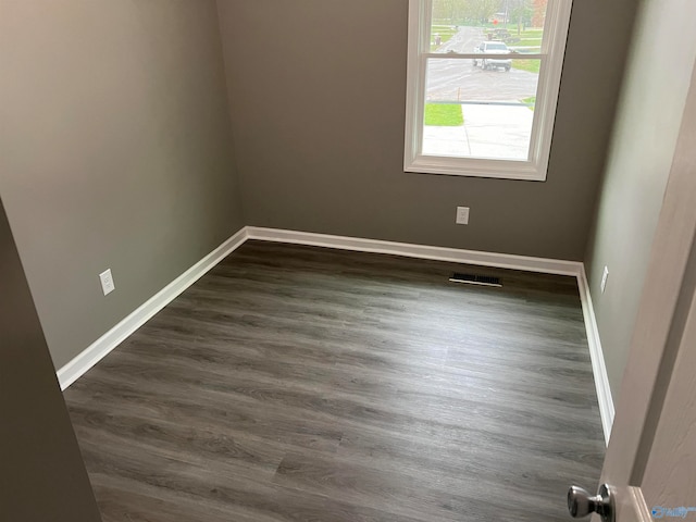 empty room with dark hardwood / wood-style floors