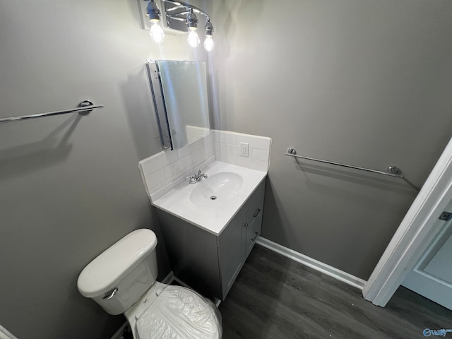 bathroom with vanity, hardwood / wood-style flooring, and toilet