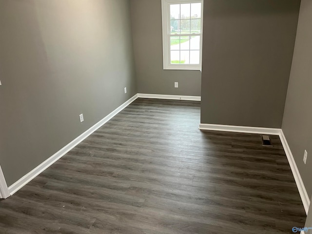 unfurnished room with dark hardwood / wood-style floors