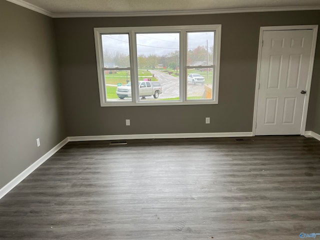 unfurnished room featuring crown molding, dark hardwood / wood-style flooring, and a textured ceiling