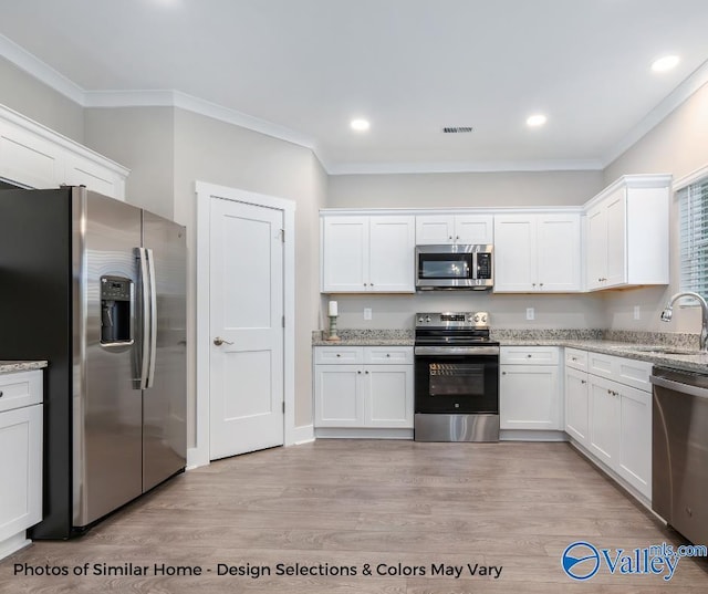 1112 Hine St, Athens, AL 35611 - kitchen featuring stainless steel appliances, sink, and white cabinets
