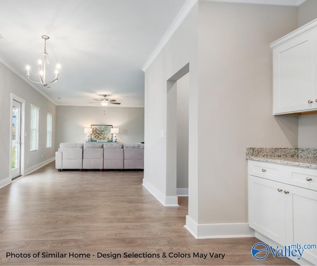 1112 Hine St, Athens, AL 35611 - interior space with crown molding, ceiling fan with notable chandelier, and light hardwood / wood-style floors