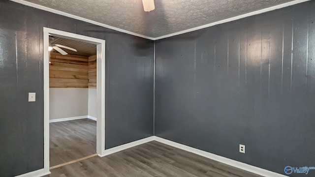 18222 Mcmunn Ln, Athens, AL 35614 - unfurnished room with ceiling fan, wood-type flooring, a textured ceiling, and wood walls