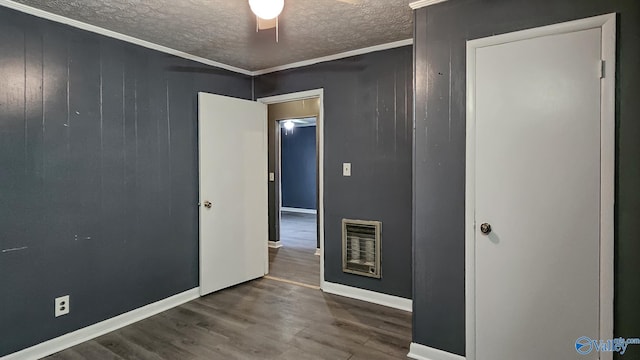 18222 Mcmunn Ln, Athens, AL 35614 - empty room featuring heating unit, ornamental molding, dark hardwood / wood-style floors, and a textured ceiling