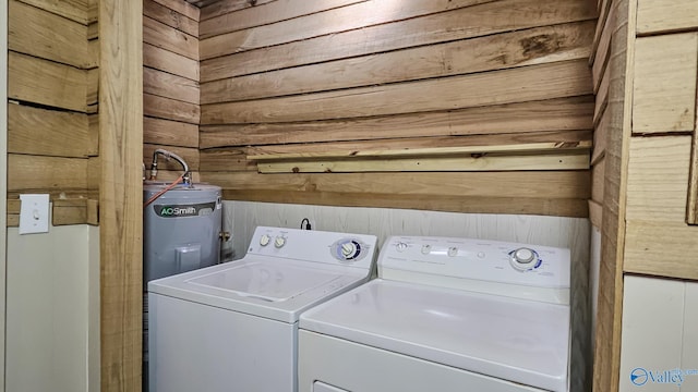 18222 Mcmunn Ln, Athens, AL 35614 - clothes washing area with washing machine and clothes dryer, water heater, and wood walls
