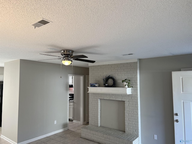 unfurnished living room with a fireplace, visible vents, a ceiling fan, and tile patterned floors