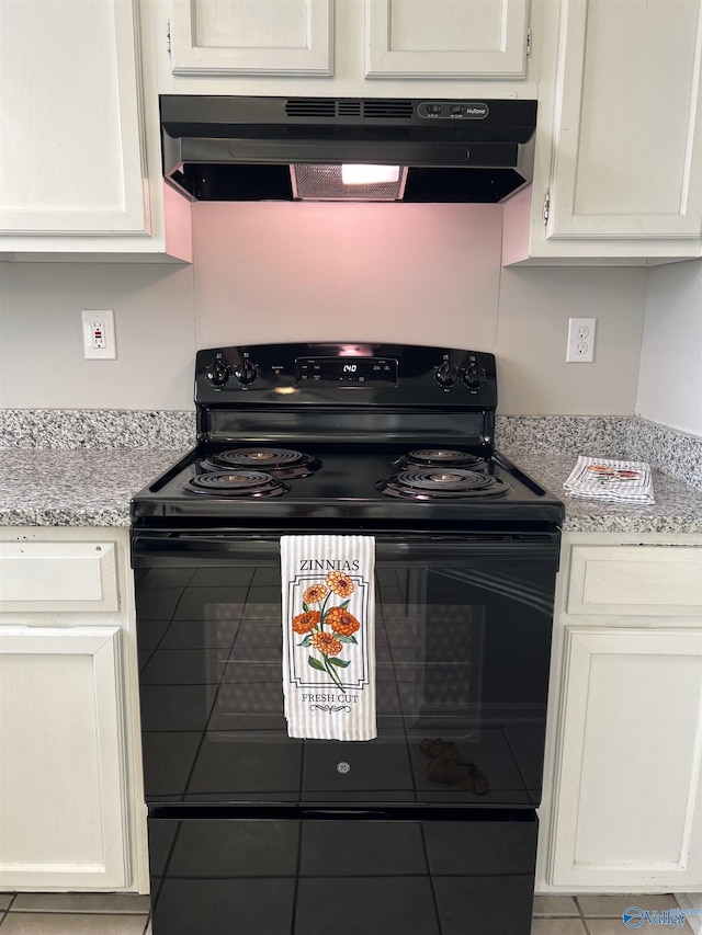 kitchen with light stone counters, ventilation hood, white cabinets, and black electric range oven