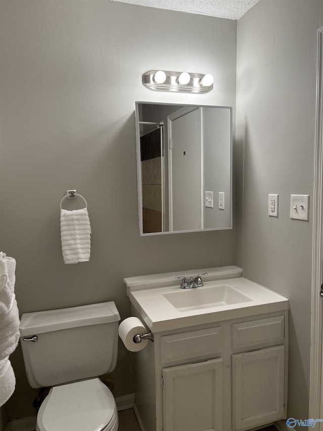 bathroom with vanity, toilet, and walk in shower