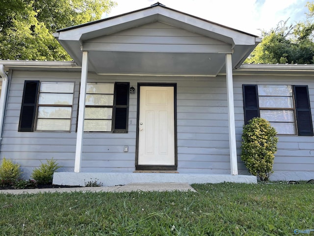 entrance to property with a yard