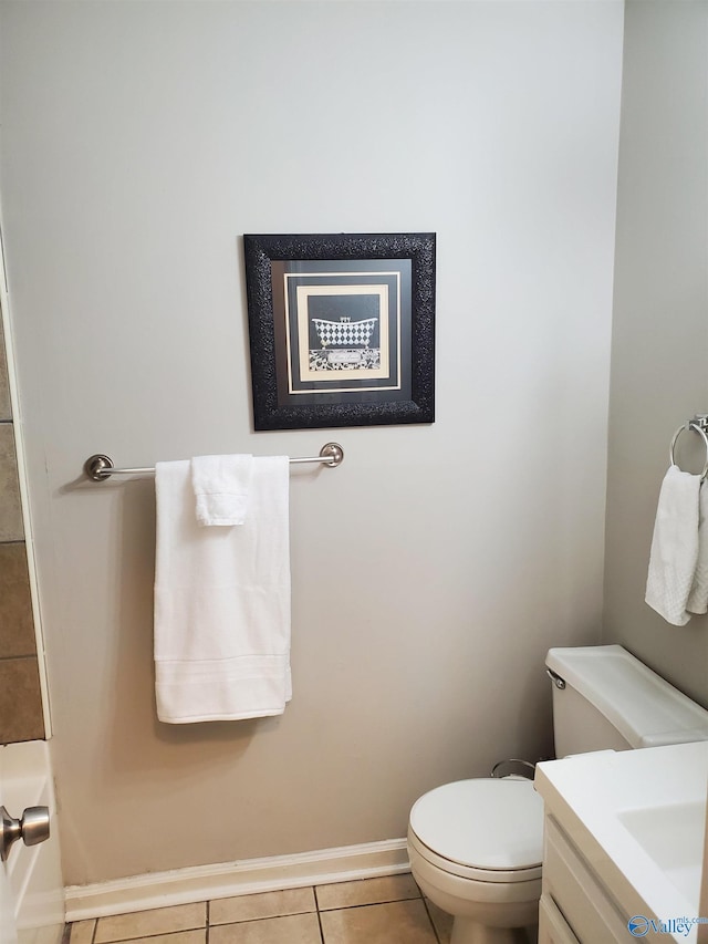 bathroom with toilet, vanity, baseboards, and tile patterned floors