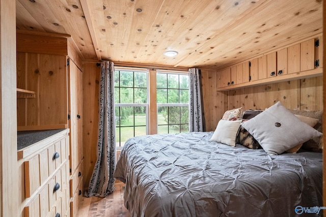 bedroom featuring wooden walls, hardwood / wood-style floors, and wood ceiling