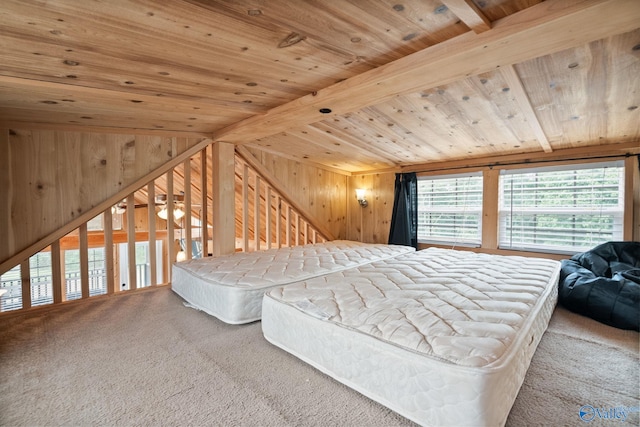 carpeted bedroom with beam ceiling, wooden walls, and wooden ceiling