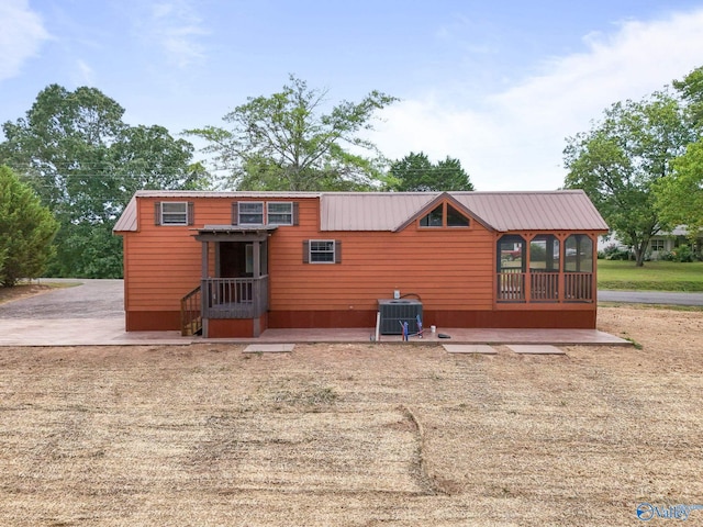back of property featuring cooling unit