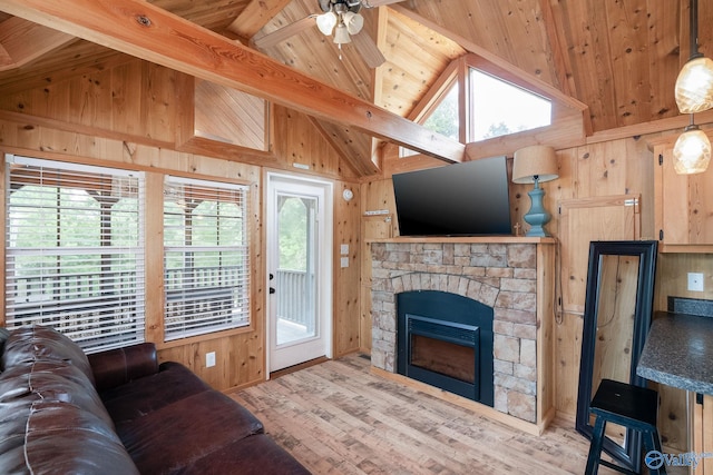 living room featuring a fireplace, ceiling fan, high vaulted ceiling, hardwood / wood-style floors, and beamed ceiling