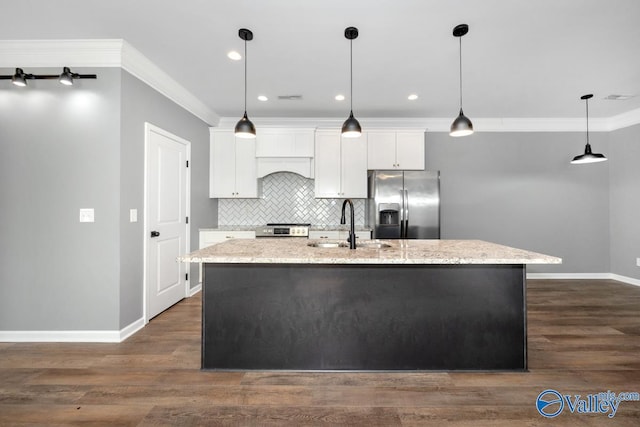 kitchen featuring white cabinetry, a center island with sink, and appliances with stainless steel finishes